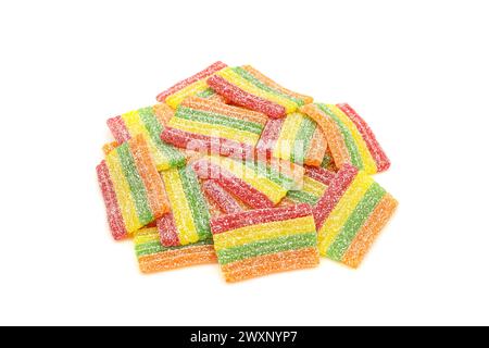 Pile of sugar sprinkled rainbow sour gummy candies isolated on white background Stock Photo