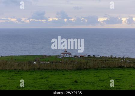 The green landscape and the Atlantic Ocean around the Lighthouse Farol da Ponta da Ferraria. Island Sao Miguel, Azores, Portugal. Stock Photo