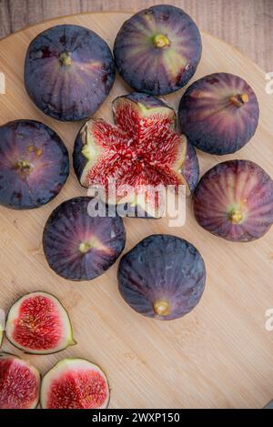 Fresh figs on wooden plate.Delicious fresh figs. wooden background. Stock Photo