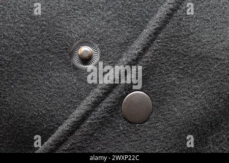 Mettallic clasp button on black jacket close-up Stock Photo