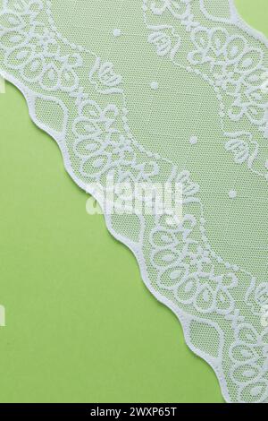 White lace on green background, top view Stock Photo