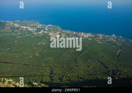 View from Ay petri mountain towards the crimean sea, with visible cable car lines leading to the lower station. Stock Photo