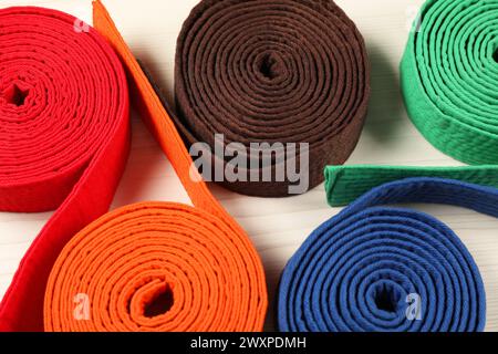 Colorful karate belts on wooden background, closeup Stock Photo