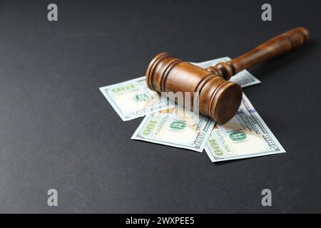 Law gavel with dollars on grey table, space for text Stock Photo
