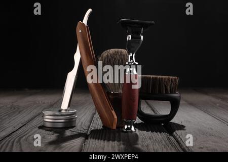 Moustache and beard styling tools on wooden table Stock Photo