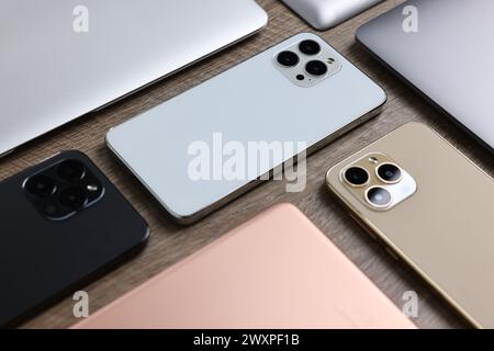Many different modern gadgets on wooden table Stock Photo