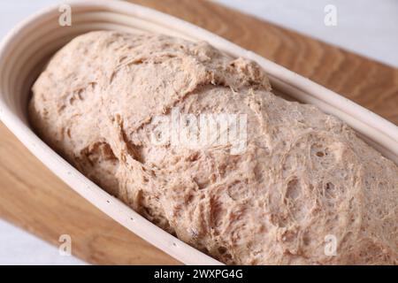 Fresh sourdough in proofing basket on table, closeup Stock Photo