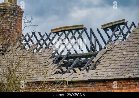 Fire damaged roof on an abandoned derelict house Stock Photo
