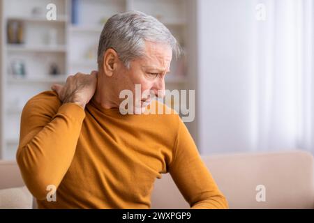 Senior man suffering from shoulder pain Stock Photo