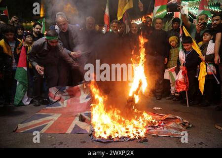 Tehran, Iran. 1st Apr, 2024. Iranians burn Israel, US, and UK flags during an anti-Israeli demonstration at Palestine Square in Tehran. Israel on 01 April launched an airstrike targeting the Iranian consulate building in Damascus. An Israeli airstrike that demolished Iran's consulate in Syria killed two Iranian generals and five officers. The attack in Syria killed Gen. Mohammad Reza Zahedi, an Iranian senior military officer in the Islamic Revolutionary Guard Corps (IRGC) and one of the top commanders of the Quds Force. Credit: ZUMA Press, Inc./Alamy Live News Stock Photo