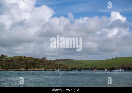 View along Salcombe Estuary from North Sands with Snapes point and Scoble point in view in the distance, blue sky and big white clouds Stock Photo