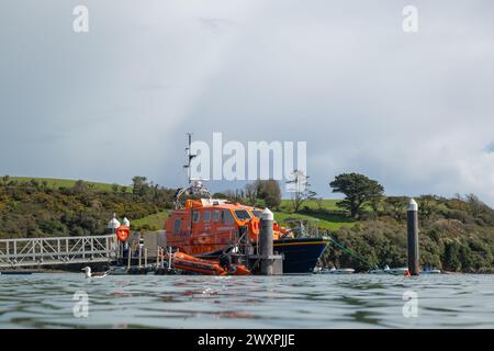 View of Salcombe all weather lifeboat, The Baltic Exchange III, taken from a low angle on harbour wall, with Snapes Point in the background. Stock Photo