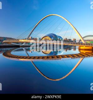 View at dawn of Gateshead Millennium Bridge viewed from Newcastle quayside looking towards The Glasshouse International Centre for Music Stock Photo
