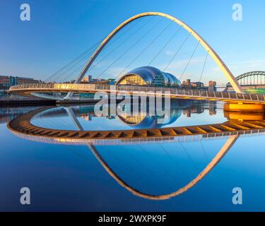 View at dawn of Gateshead Millennium Bridge viewed from Newcastle quayside looking towards The Glasshouse International Centre for Music Stock Photo