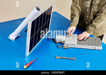 Fully autonomous Smart Solar LED Street Light With All In One Design, installing panel and lamp on mounting bracket. Stock Photo