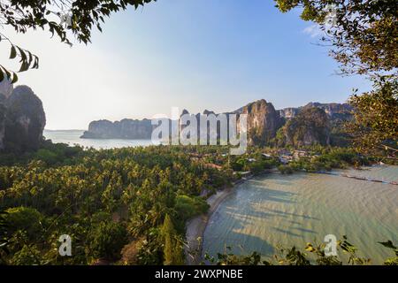 Scenic landscape of the lush Railay peninsula with steep limestone karst cliffs and mountains viewed from above on a sunny day in Krabi, Thailand. Stock Photo