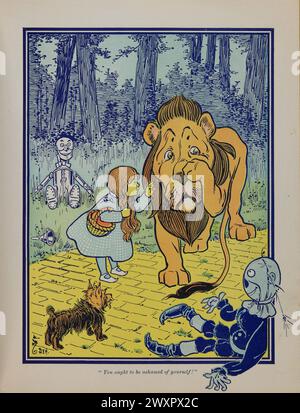 'You ought to be ashamed of yourself !'. Where the cowardly lion is admonished by Dorothy, after attacking the tin woodman and the scarecrow. Vintage Book illustration from The first edition  of The Wonderful Wizard of Oz by Frank Baum, 1900.  artwork by William W. Denslow Stock Photo
