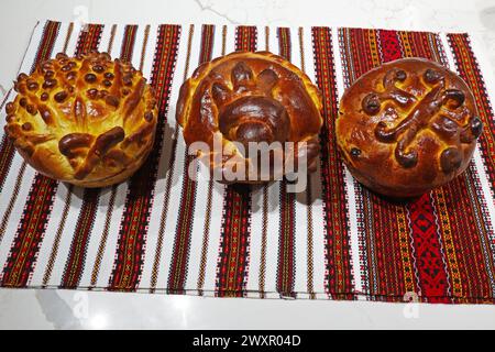 Three Easter cake on a towel with colorful embroidery Stock Photo