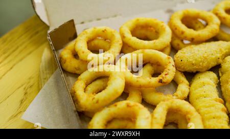 Set of takeaway paper boxes with different fast food, french fries, nuggets, onion rings and different sauces  Stock Photo