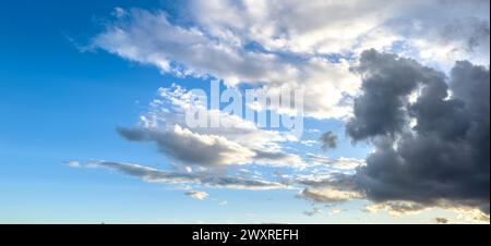White and grey fluffy cloud against clear sky background texture summer day. Stormy cumulus in blue heaven. Wallpaper. Copy space Stock Photo