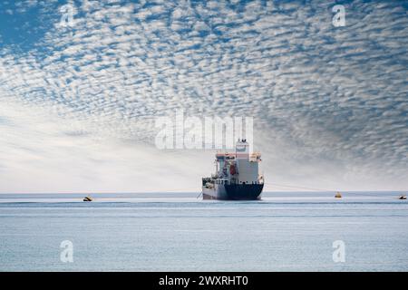 Oil chemical tanker anchored in the Mediterranean sea on a cloudy day Stock Photo