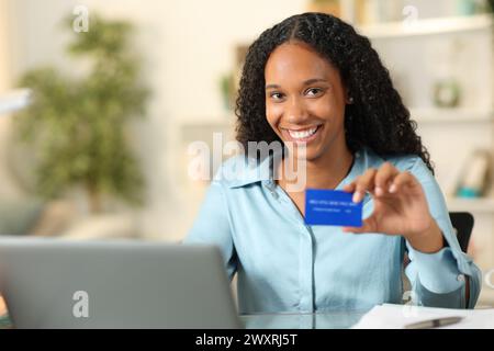 Happy black teleworker buying online posing looking at camera at home Stock Photo