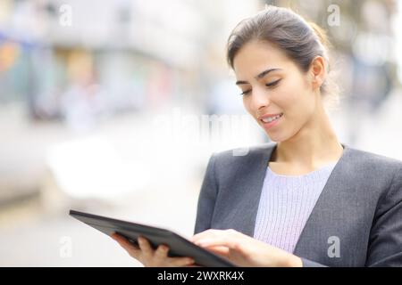 Executive using tablet standing in the street Stock Photo