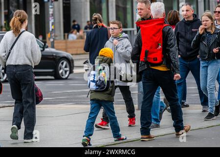 Berlin, Germany. 1st Apr, 2024. A young boy is taken for a walk through Potsdamer Platz with a replica semi-automatic rifle sticking out of his Star Wars rucksack. Spring in Berlin. Credit: Guy Bell/Alamy Live News Stock Photo