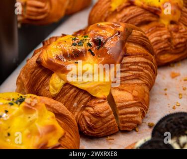 A closeup shot of savory croissants displayed on a bakery shelf Stock Photo