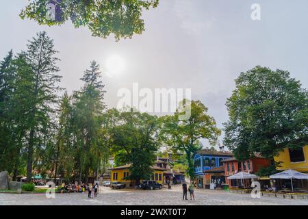 Koprivshtitsa, Bulgaria - September 24, 2023: Street scene with cafe, shops, locals, and visitors, in Koprivshtitsa, Bulgaria Stock Photo