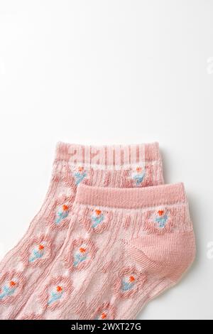 Pink socks with pattern on white background Stock Photo