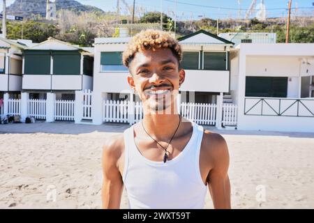 Portrait of happy young Latin man smiling looking at the camera on the beach Stock Photo
