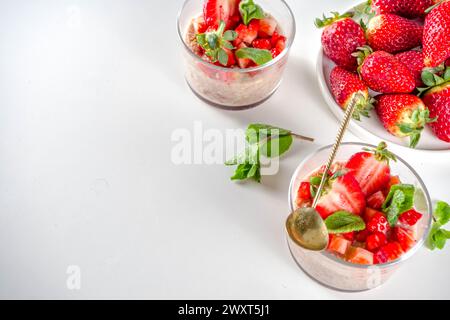 Set various fruit overnight oatmeal. Oats porridge with strawberry, bananas, chocolate, nuts in small portion jars. Summer breakfast oatmeal. Healthy Stock Photo