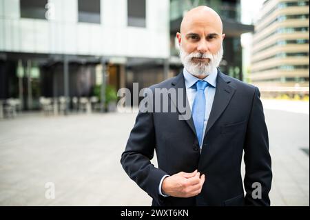 Mature bald stylish business man portrait with a white beard outdoor Stock Photo