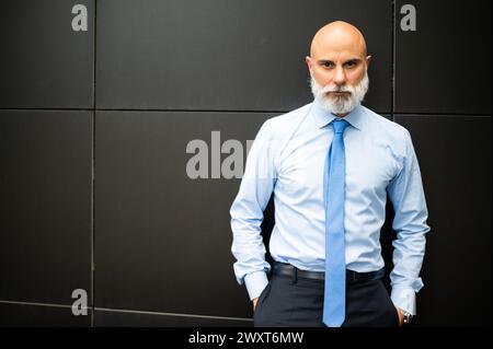 Mature bald stylish business man portrait with a white beard outdoor Stock Photo