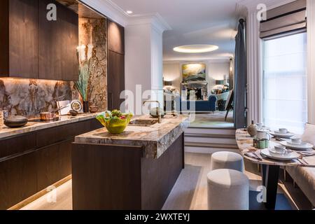 Marble kitchen with dining area in split-level Chelsea townhouse, West London, UK Stock Photo