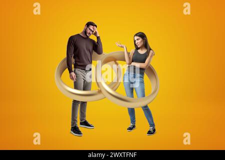 Couple in an entangled gold ring illusion Stock Photo