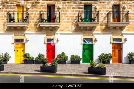 Marsaxlokk, Malta - Traditional maltese vintage house with orange, blue, yellow, red, green and brown doors and windows Stock Photo