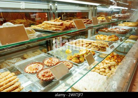 Delectable Assortment of Pastries and Sweets on Display at a Bakery Shop Stock Photo