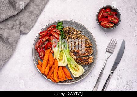 Food photography of roasted chicken, fillet, bok choy, tomato,  fried sweet potatoes, chips, cooked, cooking, cuisine, diet, dining, dinner Stock Photo