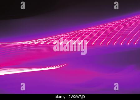 Neon pink light trails motion blurred twisting tunnel Stock Photo
