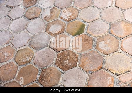 Old road pavement made of hexagonal tiles, background photo texture Stock Photo