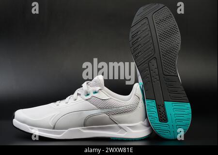 White sport shoes with black sole on studio background close up view Stock Photo