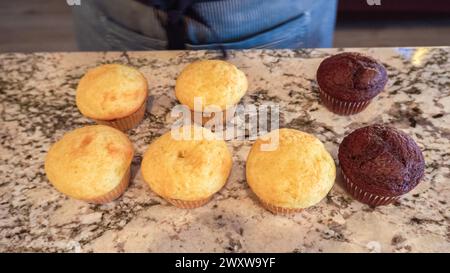 Filling Vanilla, Chocolate Cupcakes with Lemon, Raspberry Stock Photo