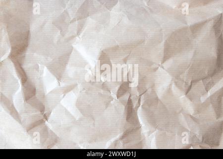 Wrinkled recycled brown brown kraft paper background. Crumpled striped paper texture. Grunge backdrop. Stock Photo