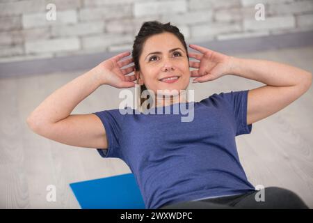 woman doing sit-ups exercises at home Stock Photo