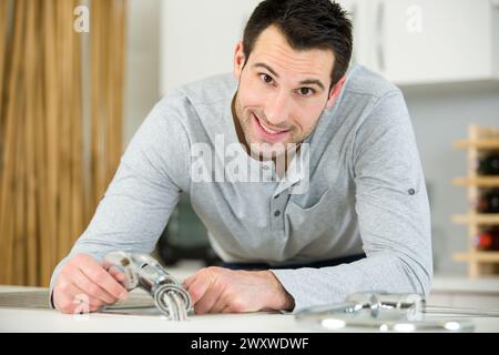 portrait of man with broken kitchen tap Stock Photo