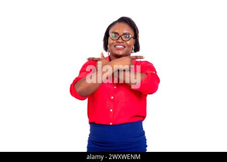 portrait of a young businesswoman pointing fingers at both sides with crossed hands while smiling. Stock Photo