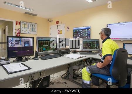 Operators working in the control room of a water distributor in the Canary Islands Stock Photo