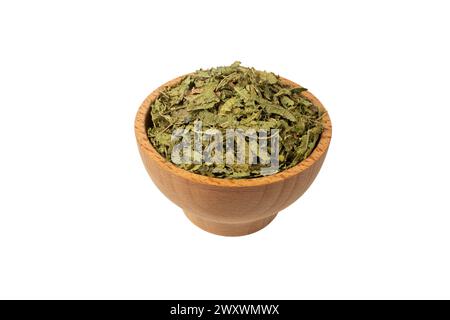 Dried leaves o Lemon verbena in latin Aloysia citrodora in wooden bowl isolated on white background. Medicinal herb. Lemon verbena leaf extract is use Stock Photo
